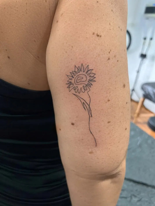 Small Linework Sunflower on Women Arm Tattoo by @ana_faganel_dotline_pmu