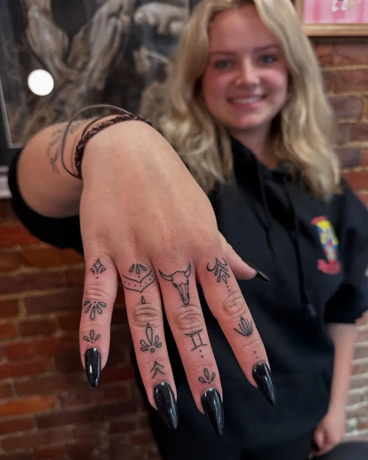 Small Linework Symbols and Skull on Women Hand Tattoo by @marita.ttoos
