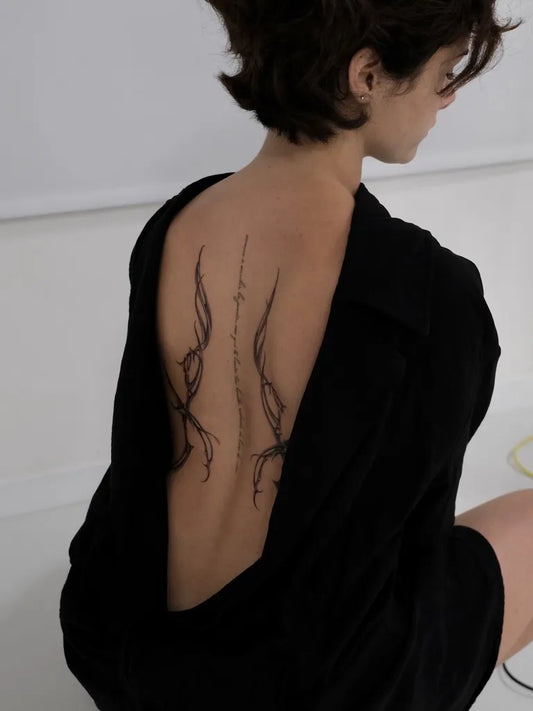 Small Linework Tendrils on Women Back Tattoo by @norte.ttt