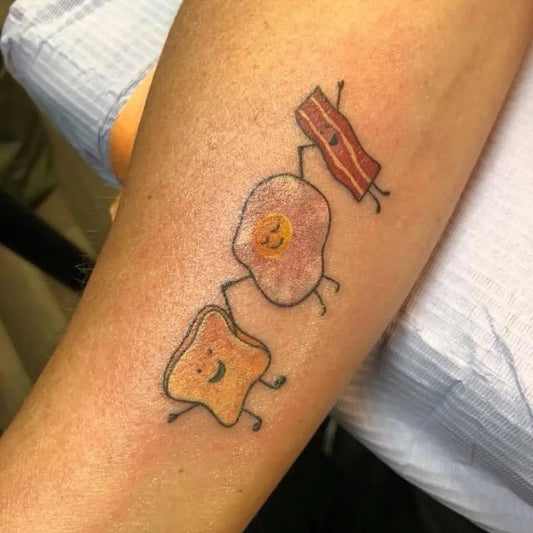 Small Linework Toast Egg Bacon on Women Arm Tattoo by @nickemtattoos