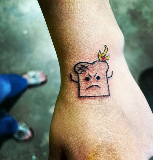 Small Linework Toast with Crown and Flame on Women Wrist Tattoo by @destination_iowa