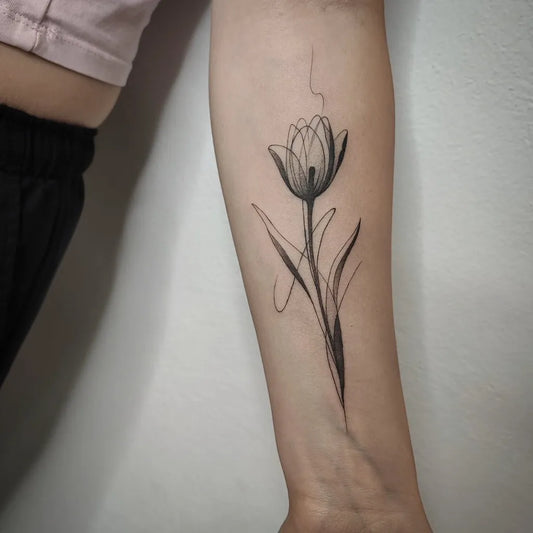 Small Linework Tulip Tattoo on Women Arm by @martius_tattooart