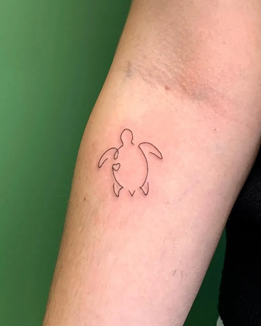 Small Linework Turtle Tattoo on Women Arm by @rieke.tattoos