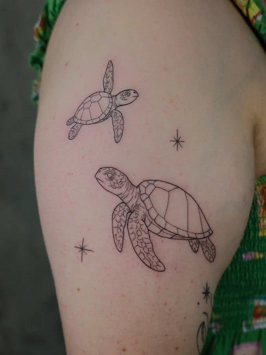 Small Linework Turtle and Stars Tattoo on Women Arm by @myb_ink