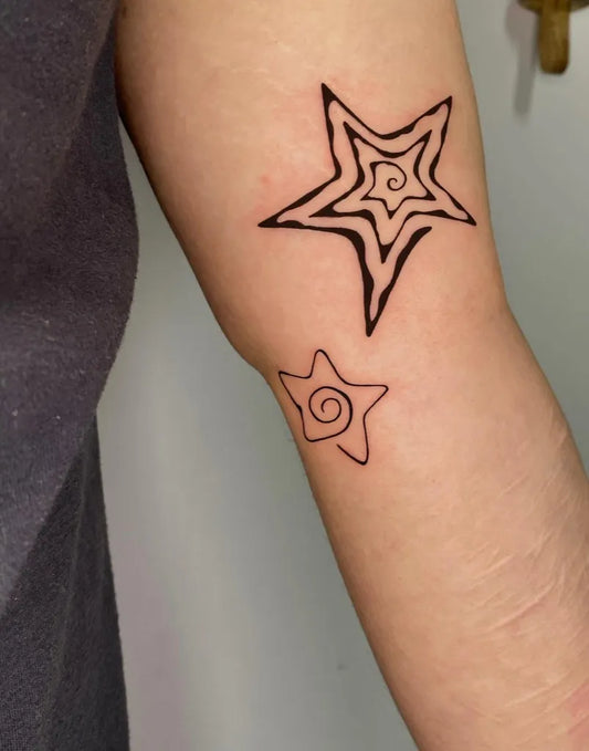 Small Linework Twin Spiral Star Tattoo on Men Arm by @solheart.ink