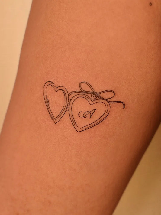Small Linework Two Linked Hearts with A on Women Thigh Tattoo by @tattooer_jina