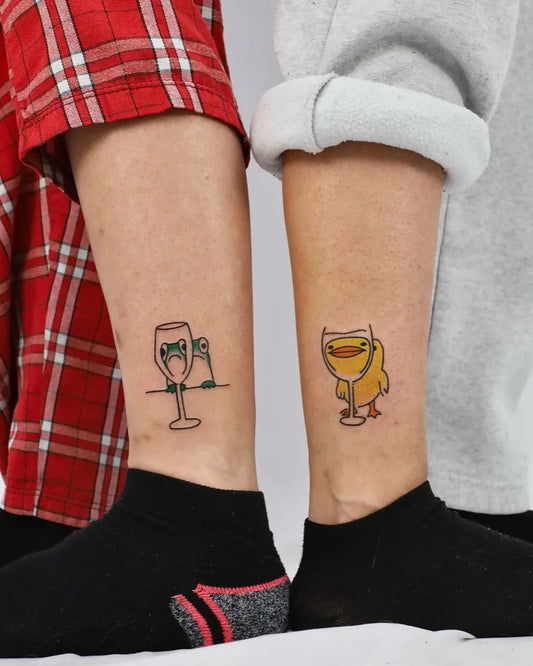 Small Linework Wine Glasses with Frogs and Duck on Couple Legs Matching Tattoo by @studiohon_