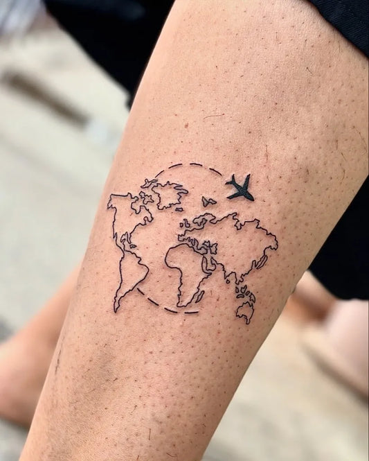 Small Linework World Map with Airplane Tattoo on Women Ankle by @ajtattoopune