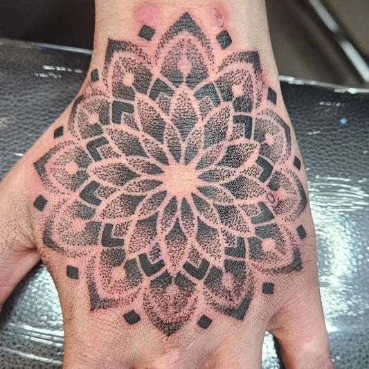 Small Mandala Flower on Men Hand Tattoo by @hannahlunt_tattoo