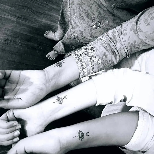 Small Matching Evil Eye Moon Symbol on Women Wrist Tattoo by @vijaytattooartist