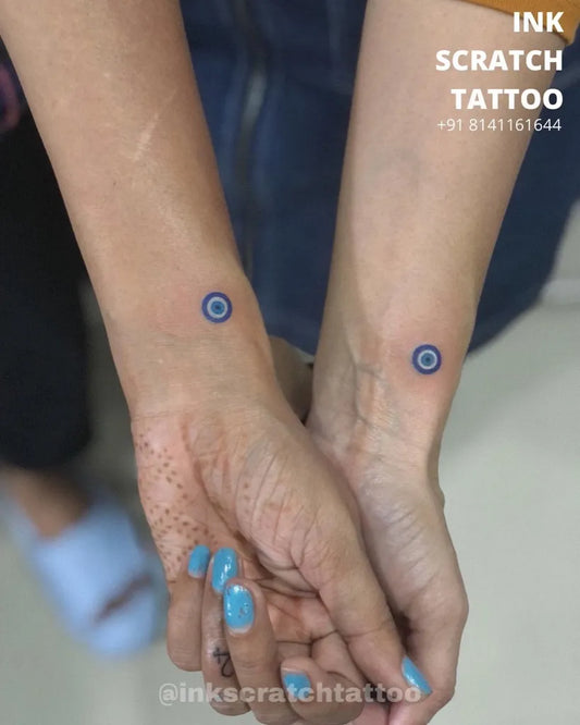 Small Matching Fine Line Evil Eye on Women Wrist Tattoo by @mitesh_tattoo_surat