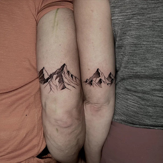 Small Matching Mountain Tattoo on Couple Arms by @mysticink.nepal