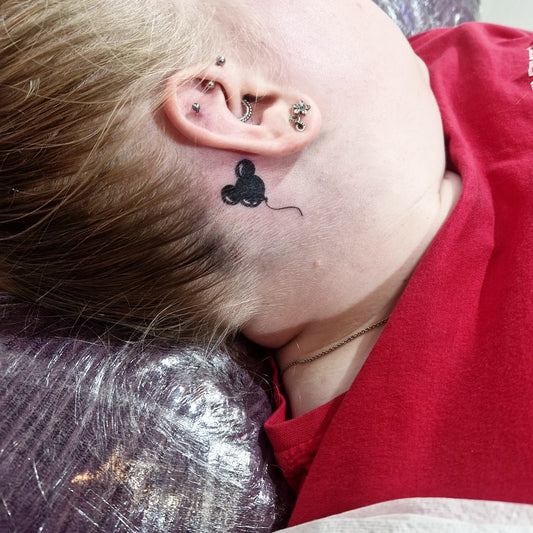 Small Mickey Mouse Balloon Tattoo on Women Behind the Ear by @mad_tatter_designs