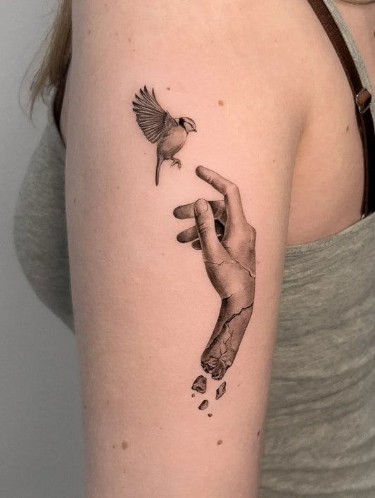 Small Micro Realism Bird and Broken Hand on Women Arm Tattoo by @selma.tattoo