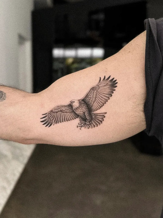 Small Micro Realism Flying Eagle on Men Arm Tattoo by @alexlloydtattoo