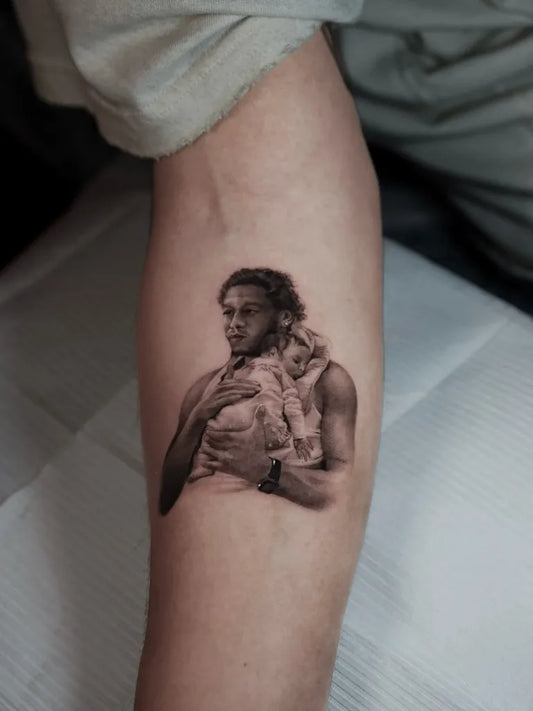 Small Micro Realism Man with Baby on Men Arm Tattoo by @ozloktattoo