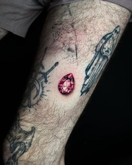 Small Micro Realism Ruby Gem on Men Arm Tattoo by @raven.eg
