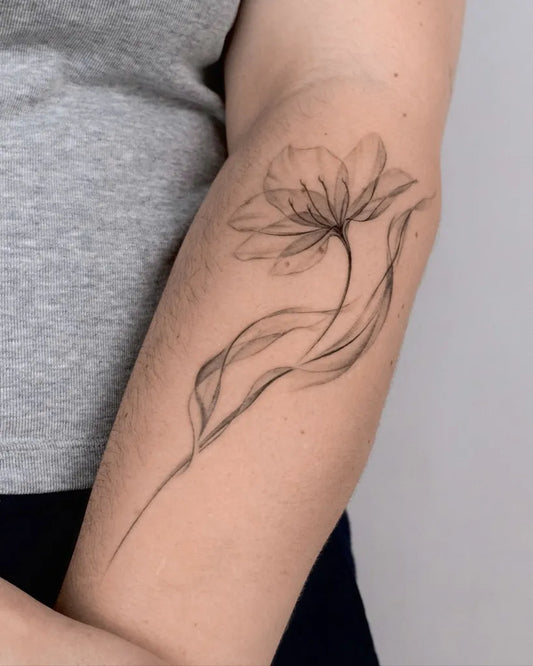 Small Micro Realism tulip flower stem on Women Arm Tattoo by @k.tatt