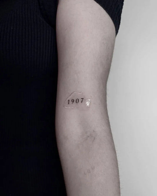Small Minimalist 1907 Number on Women Arm Tattoo by @cepytattoos