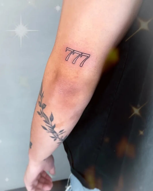 Small Minimalist 777 Outline Tattoo on Men Arm by @winona_ink