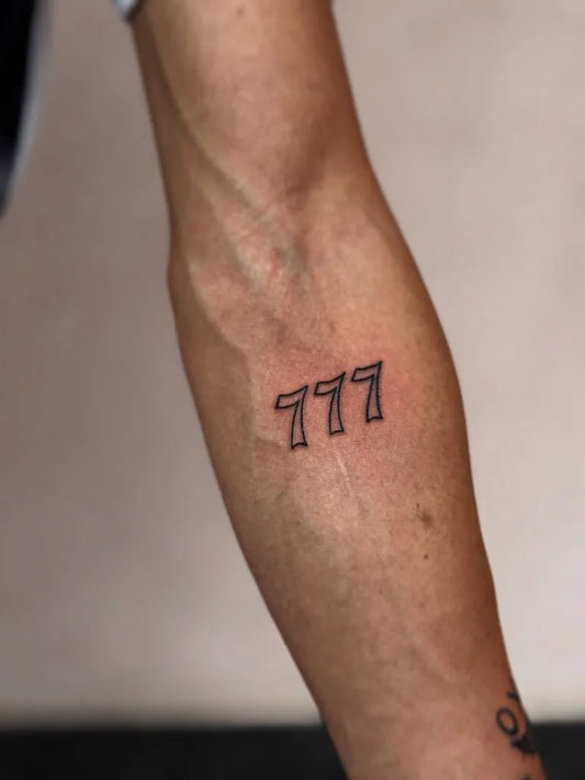 Small Minimalist 777 Outline Tattoo on Men Forearm by @mimi_inkcrafts