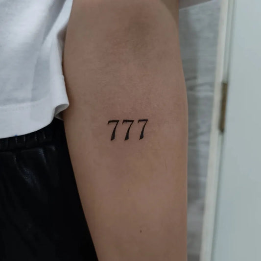 Small Minimalist 777 Tattoo on Women Arm by @99estudi0