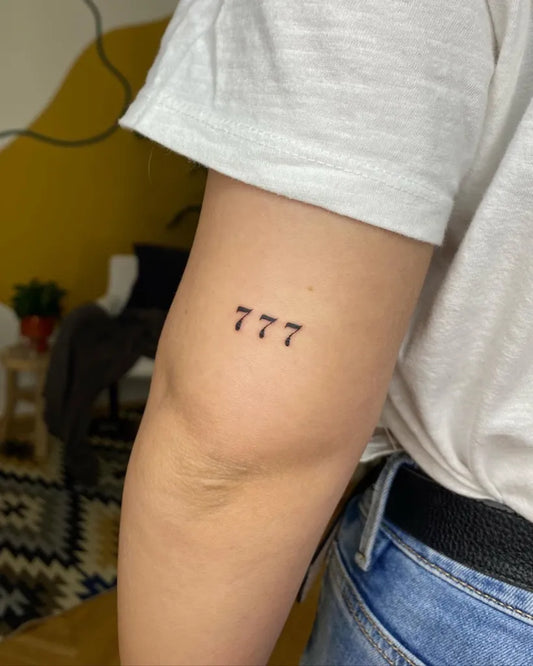 Small Minimalist 777 Tattoo on Women Arm by @colette.ink