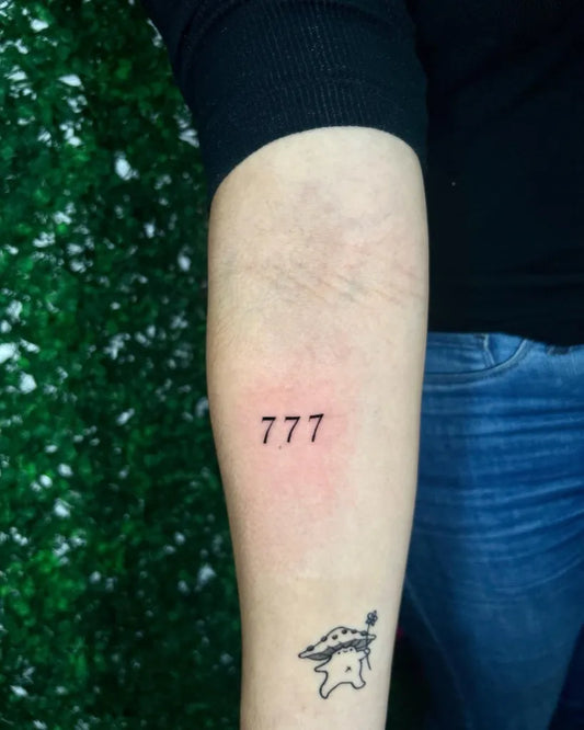 Small Minimalist 777 Tattoo on Women Arm by @mr.ken_tattoo
