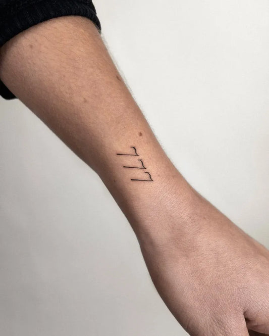Small Minimalist 777 Tattoo on Women Wrist by @hellymarch_tattoo