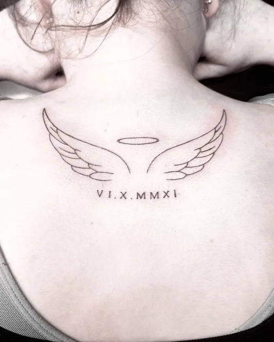 Small Minimalist Angel Wings with Halo and Date Tattoo on Women Back by @inkandescent.tattoos