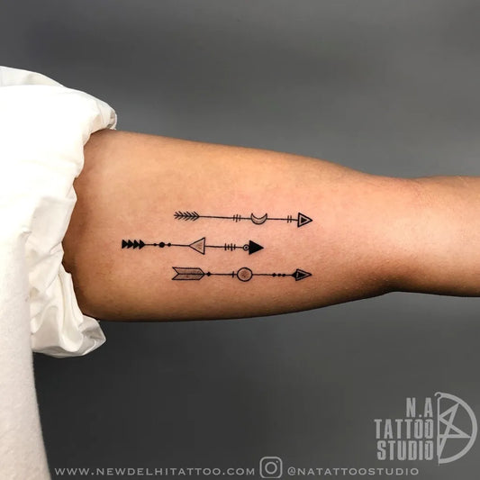 Small Minimalist Arrow Tattoo on Women Arm by @natattoostudio