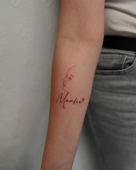 Small Minimalist Baby Face and Name on Women Arm Tattoo by @marina.inkd