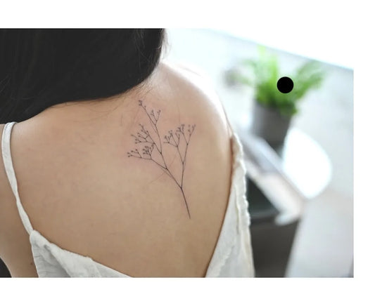 Small Minimalist Babys Breath Branch on Women Upper Back Flower Tattoo by @carly_tattooooo