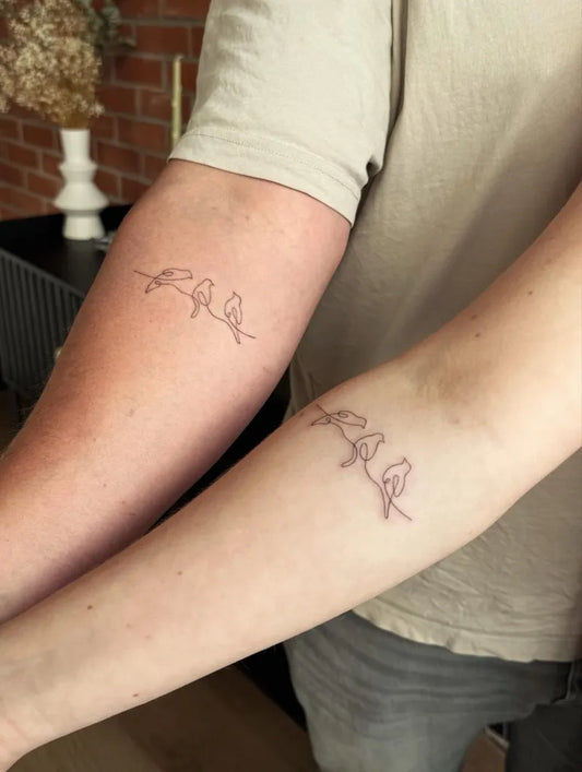 Small Minimalist Birds on Couple Arms Matching Tattoo by @rachel_tattooing