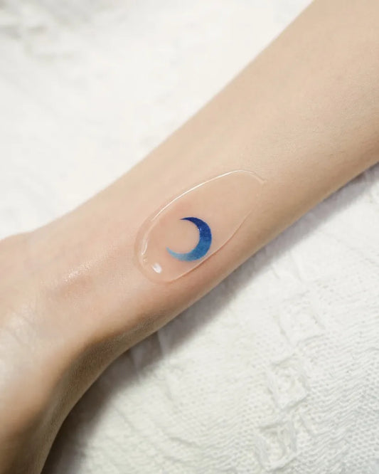 Small Minimalist Blue Crescent Moon Tattoo on Women Wrist by @lime_tattoo