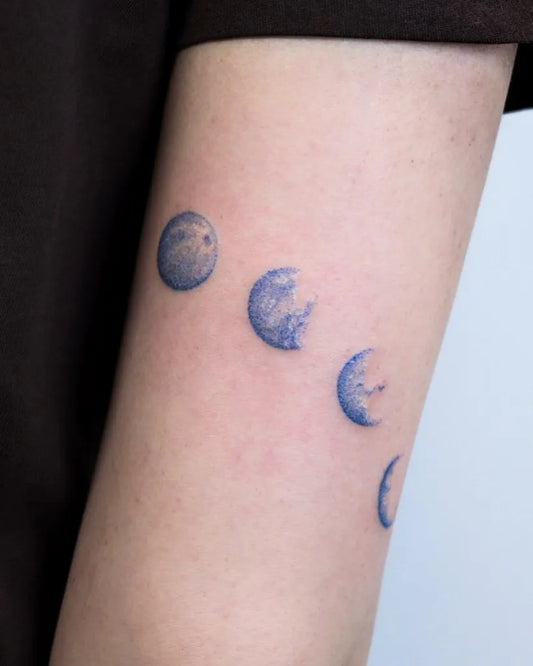 Small Minimalist Blue Moon Phases Tattoo on Women Arm by @woorin.tt