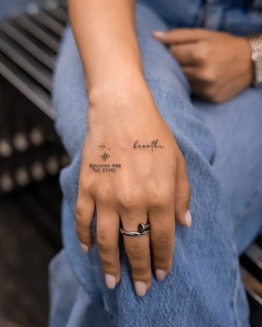 Small Minimalist Breathe Text Compass on Women Hand Tattoo by @karl_thetattoo_plug