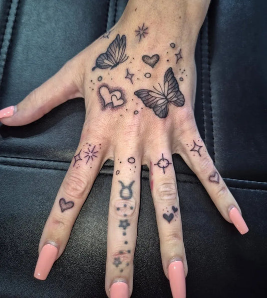 Small Minimalist Butterflies Hearts Stars on Women Hand Tattoo by @whelantattoo