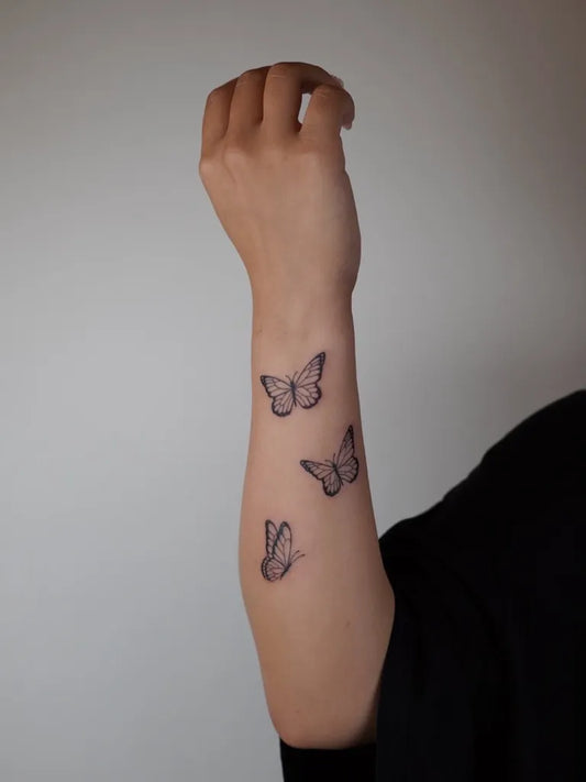 Small Minimalist Butterflies on Women Forearm Tattoo by @julsietattoos