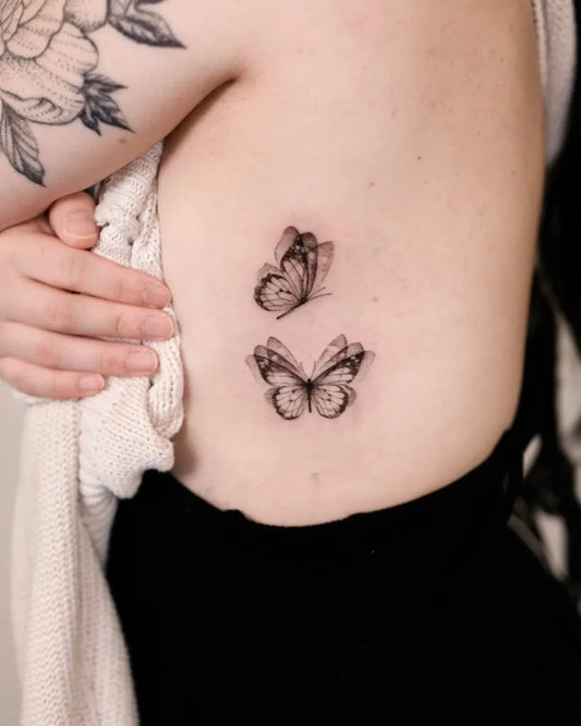 Small Minimalist Butterflies on Women Rib Tattoo by @bamnavi_tattoo