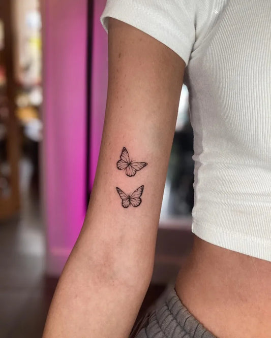 Small Minimalist Butterflies on Women Upper Arm Tattoo by @sonsofink