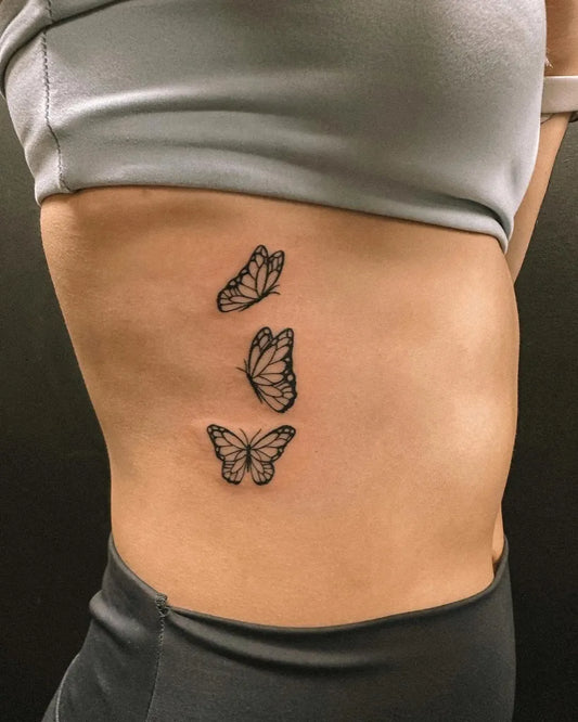 Small Minimalist Butterflies on Women Waist Tattoo by @hybridink.helsinki