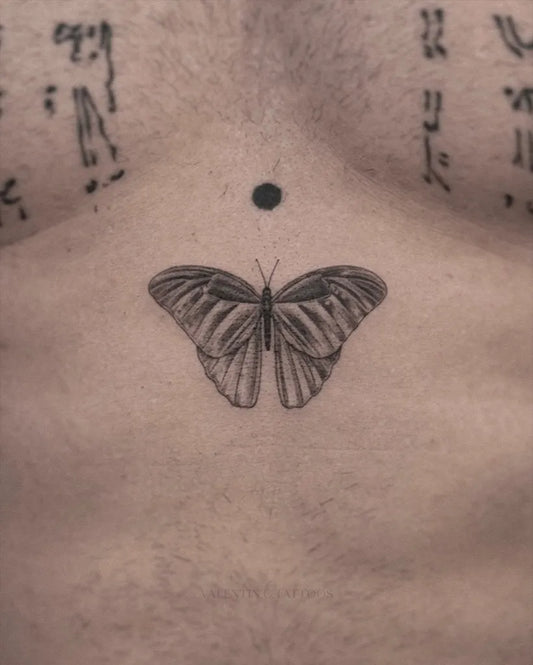 Small Minimalist Butterfly on Men Chest Tattoo by @valentin.c.tattoos