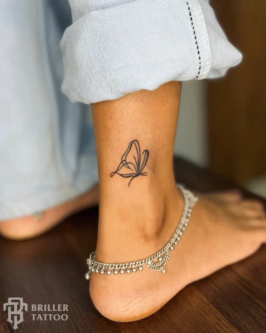 Small Minimalist Butterfly on Women Ankle Tattoo by @briller_tattoo_studio