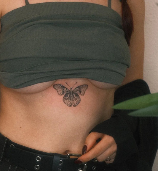 Small Minimalist Butterfly on Women Chest Tattoo by @lovemore.tattoo