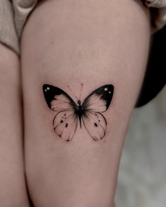 Small Minimalist Butterfly on Women Thigh Tattoo by @tattoo.gaia
