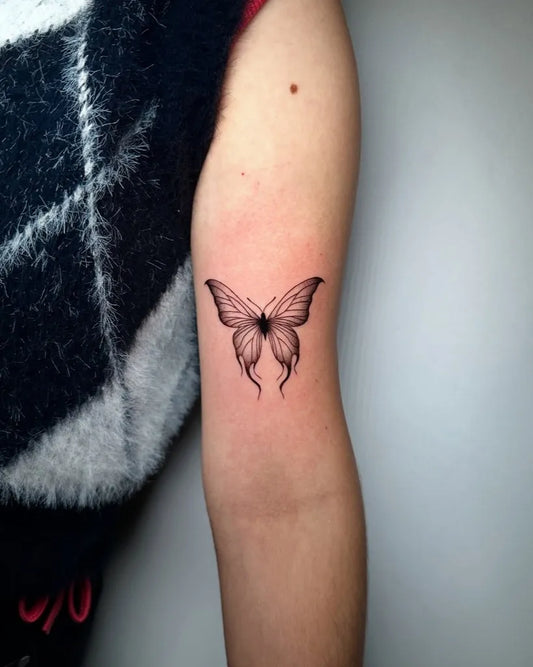 Small Minimalist Butterfly on Women Upper Arm Tattoo by @eduardopardotattoo
