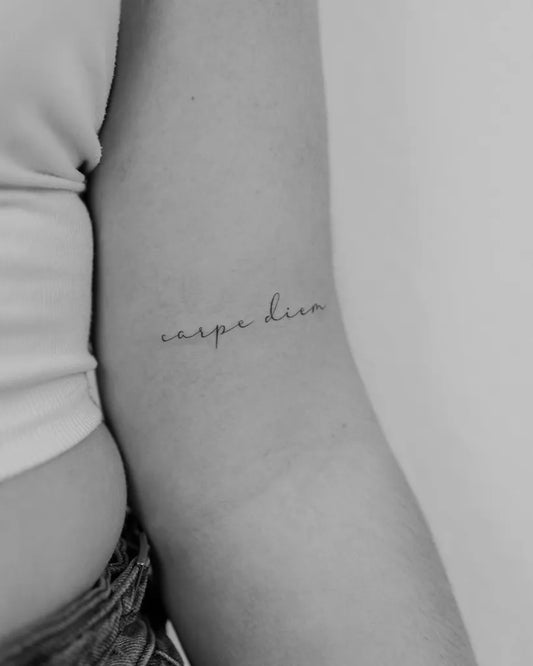 Small Minimalist Carpe Diem on Women Arm Tattoo by @tattoo.ines