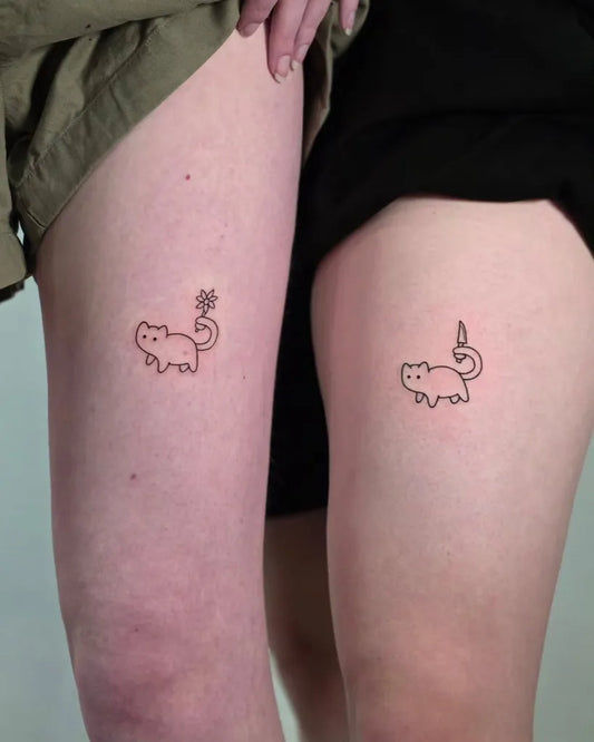 Small Minimalist Cat with tail on Couple on Thighs Matching Tattoo by @chonify.inks