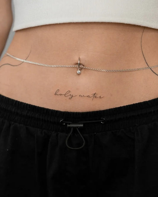 Small Minimalist Chain Belly Ring Script on Women Stomach Tattoo by @tattoo.ines